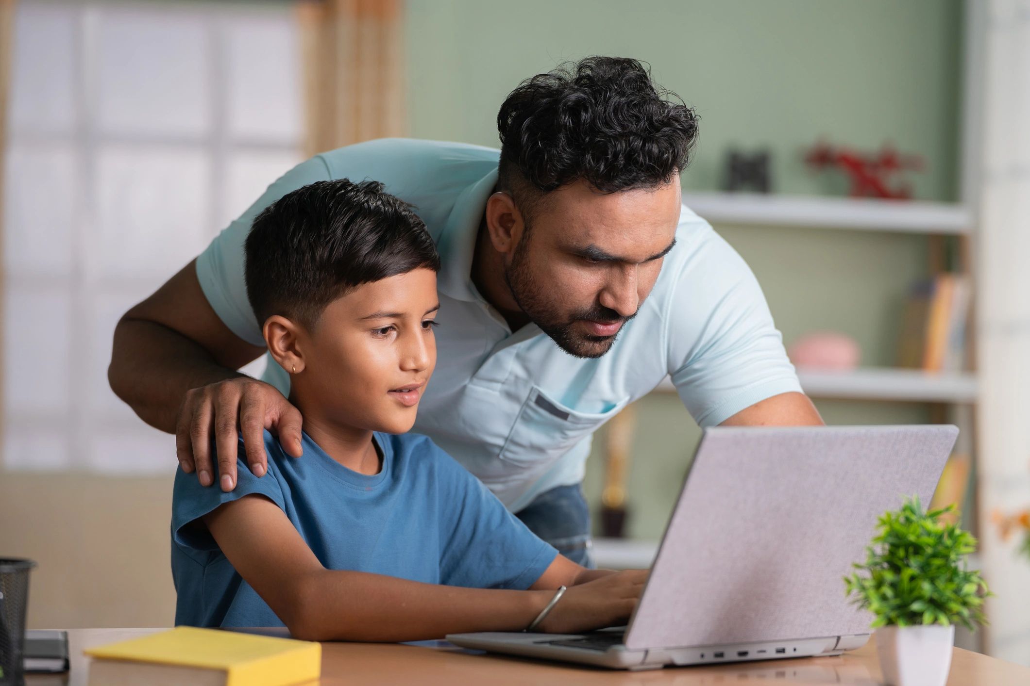 Parent and child using a computer together