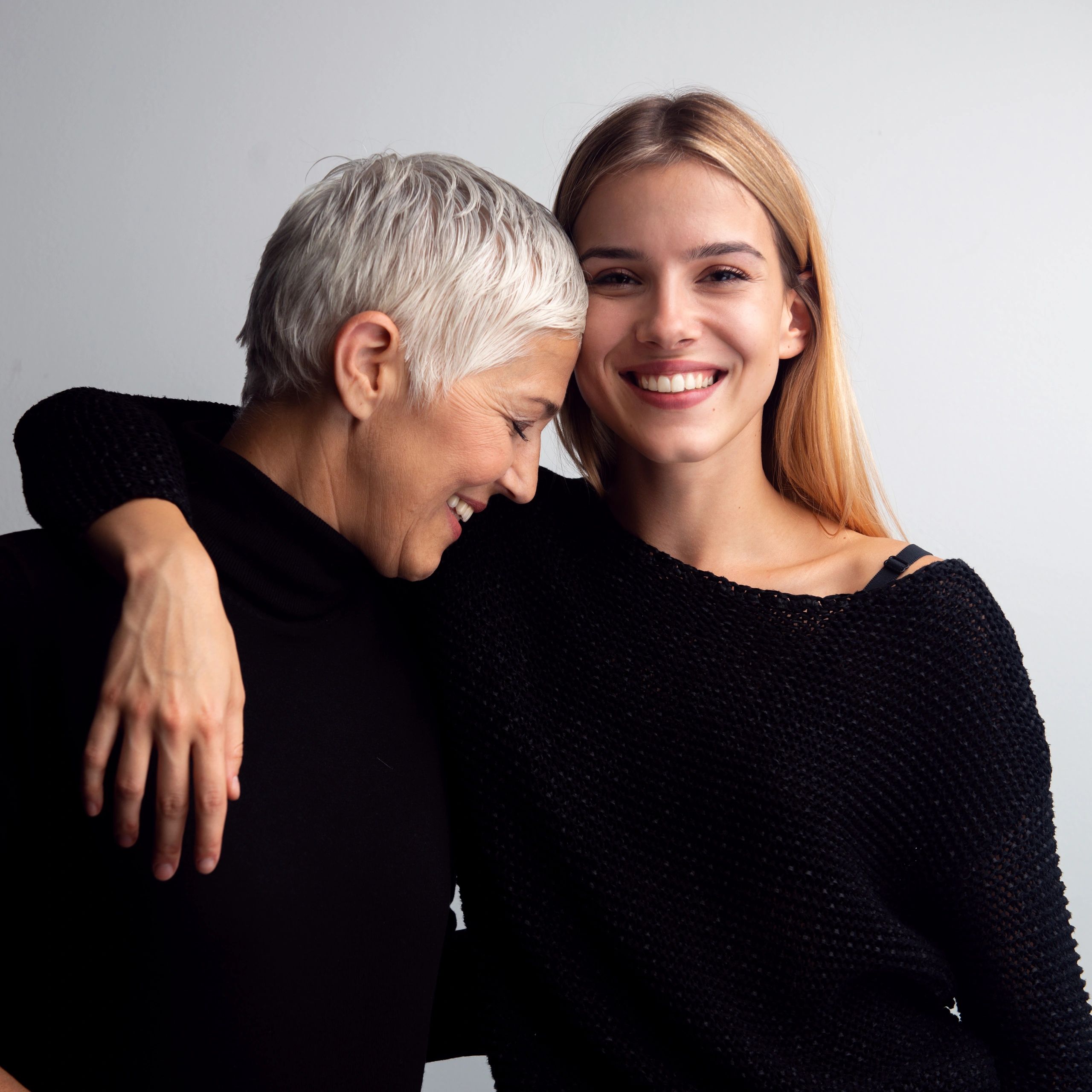 Studio portrait of mother and daughter