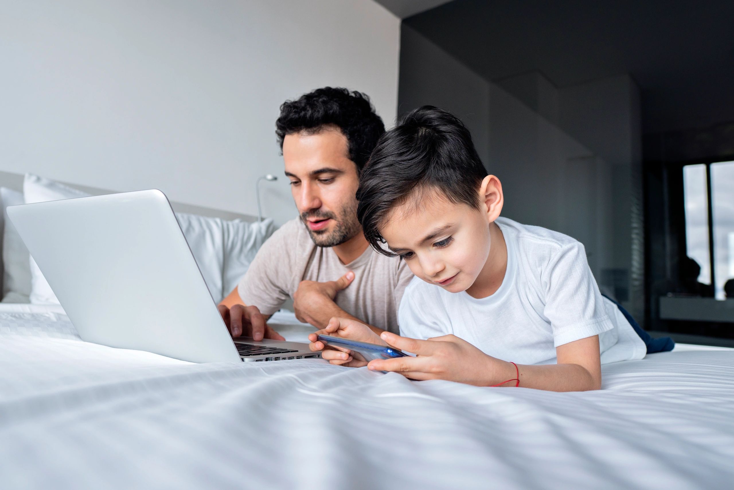 Parent and child using a laptop at home