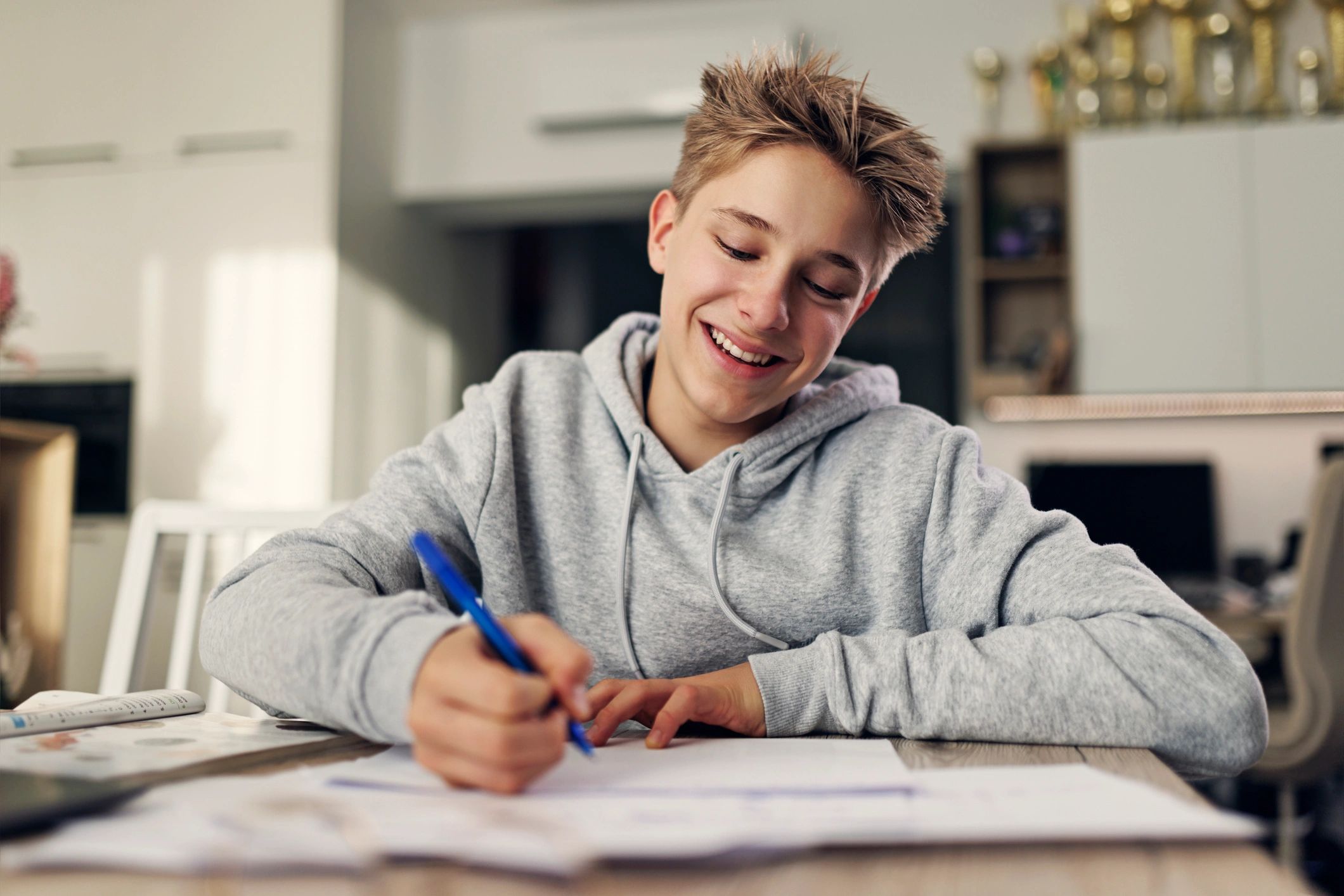Kid wearing a hoodie while studying at home