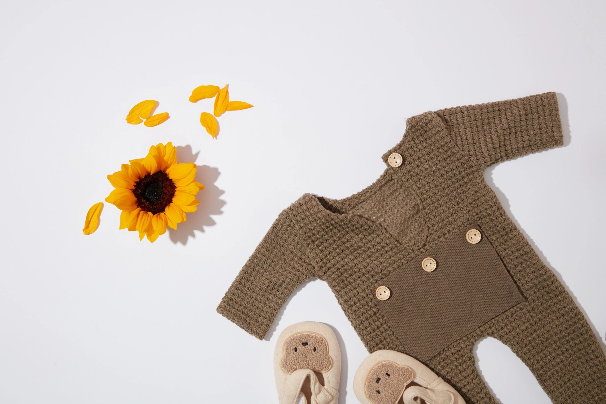 Minimal product photo of baby outfit on white background